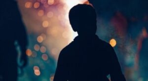 A young boy attending a local Bonfire Night event in his local community.