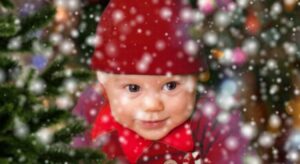 A baby dressed up in a Christmas outfit at nursery